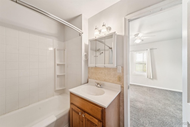 full bath with a ceiling fan, vanity, and washtub / shower combination