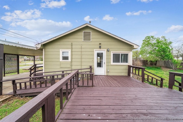 deck featuring a lawn and fence