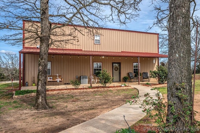 view of front of house featuring central air condition unit, covered porch, and board and batten siding