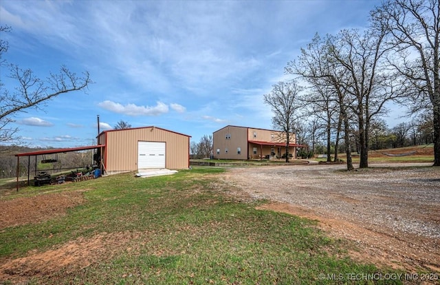 exterior space featuring an outbuilding, driveway, and a garage