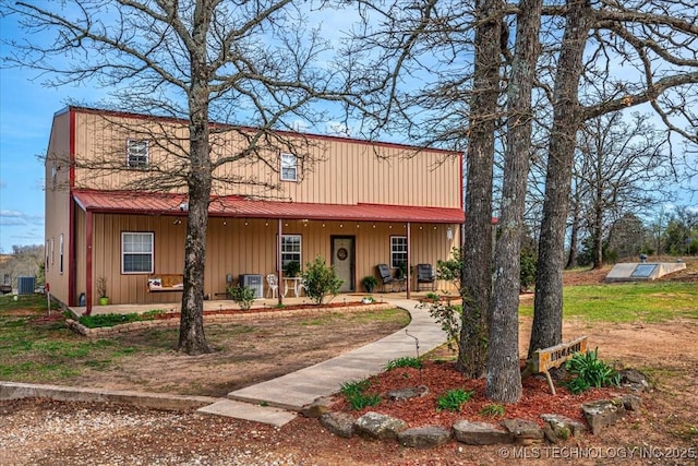 view of front of property with covered porch and central air condition unit