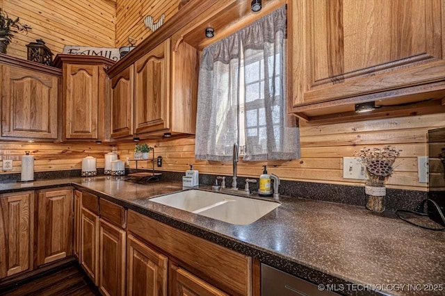 kitchen featuring a sink, dark countertops, and brown cabinets