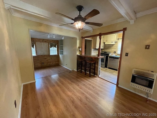 interior space with crown molding, ceiling fan, heating unit, and light wood-style flooring