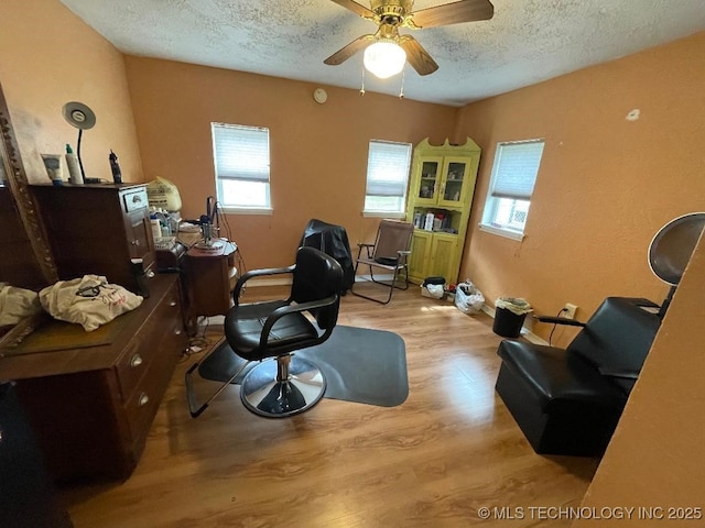 office space featuring a textured ceiling, ceiling fan, and wood finished floors