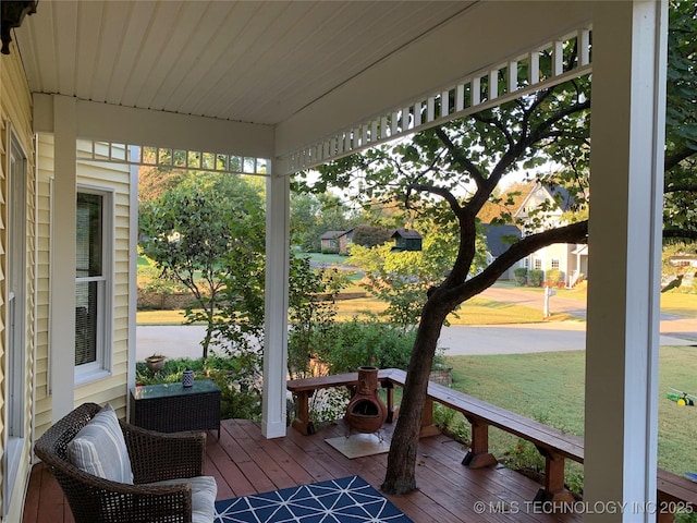 wooden terrace with a yard