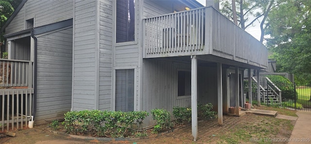 7502 S Winston Pl Unit 203, Tulsa, OK 74136 - view of property exterior with a wooden deck and stairway
