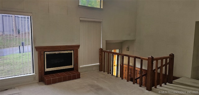 7502 S Winston Pl Unit 203, Tulsa, OK 74136 - stairs with healthy amount of natural light, carpet floors, and a towering ceiling