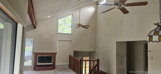 7502 S Winston Pl Unit 203, Tulsa, OK 74136 - living room featuring high vaulted ceiling, a ceiling fan, and a textured ceiling