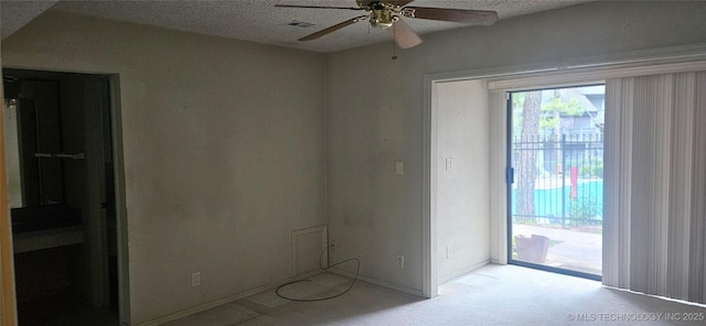 7502 S Winston Pl Unit 203, Tulsa, OK 74136 - carpeted empty room featuring a ceiling fan, baseboards, and a textured ceiling