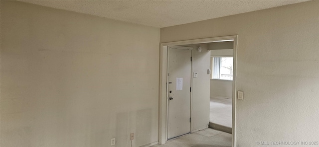 7502 S Winston Pl Unit 203, Tulsa, OK 74136 - hall with a textured ceiling