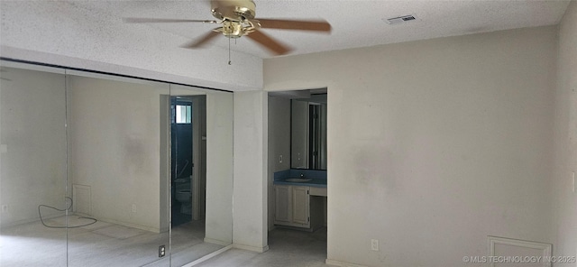 7502 S Winston Pl Unit 203, Tulsa, OK 74136 - unfurnished bedroom featuring a sink, ensuite bathroom, and baseboards