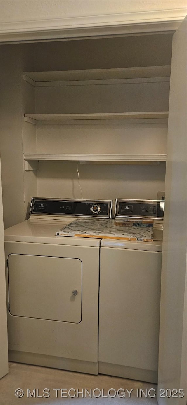 7502 S Winston Pl Unit 203, Tulsa, OK 74136 - laundry room with washer and clothes dryer