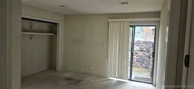 7502 S Winston Pl Unit 203, Tulsa, OK 74136 - unfurnished bedroom with access to exterior, carpet flooring, a textured ceiling, and a closet