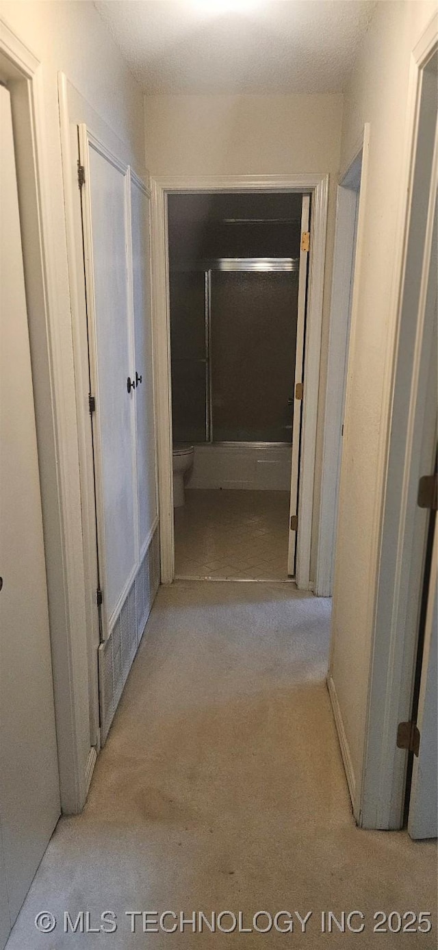 7502 S Winston Pl Unit 203, Tulsa, OK 74136 - corridor featuring carpet flooring