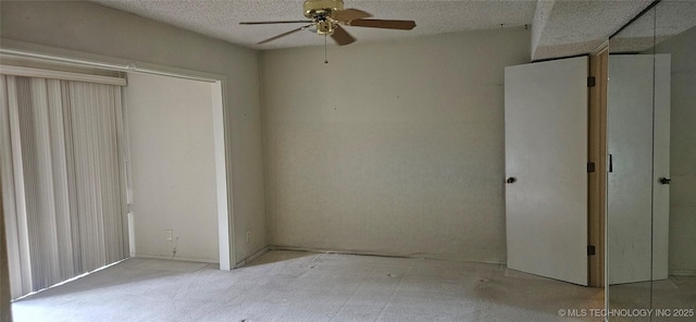 7502 S Winston Pl Unit 203, Tulsa, OK 74136 - unfurnished bedroom featuring a textured ceiling and a ceiling fan