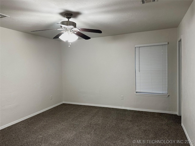 12924 E 34th St, Tulsa, OK 74134 - spare room featuring baseboards, a textured ceiling, a ceiling fan, and dark colored carpet