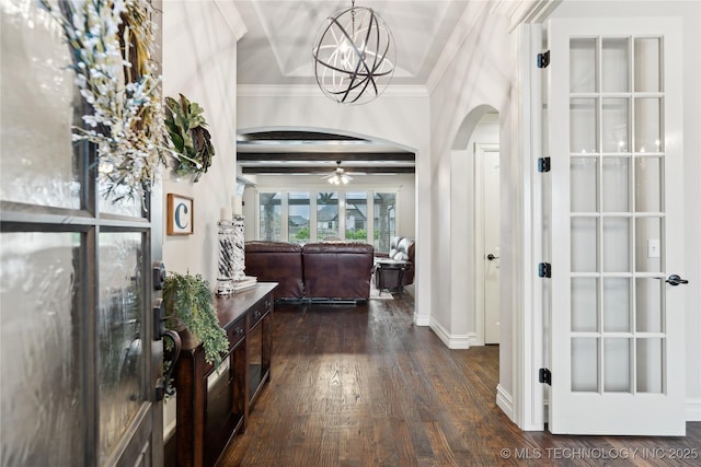 19672 E 69th St N, Owasso, OK 74055 - foyer featuring arched walkways, dark wood finished floors, a chandelier, crown molding, and baseboards
