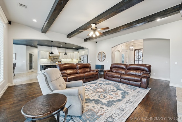 19672 E 69th St N, Owasso, OK 74055 - living room with arched walkways, a ceiling fan, baseboards, wood finished floors, and recessed lighting