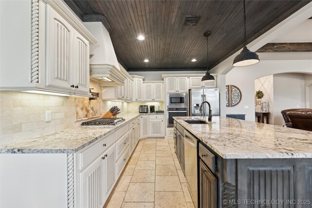 19672 E 69th St N, Owasso, OK 74055 - kitchen featuring appliances with stainless steel finishes, stone tile floors, a sink, decorative backsplash, and recessed lighting