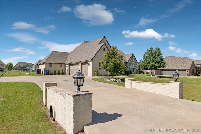 19672 E 69th St N, Owasso, OK 74055 - view of front of home with a front lawn, driveway, an attached garage, and a residential view