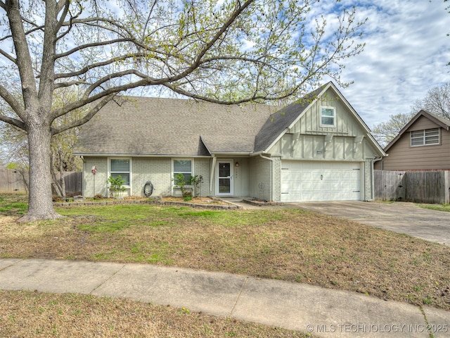 view of front of property featuring fence, brick siding, board and batten siding, roof with shingles, and driveway