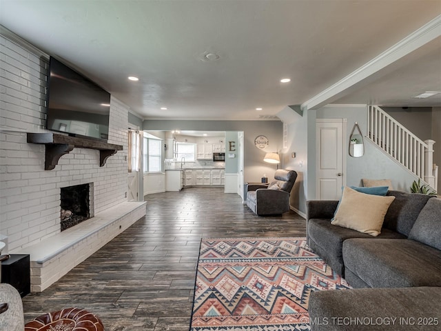 7339 S 73rd E Ave, Tulsa, OK 74133 - living room featuring dark wood-style flooring, stairway, a fireplace, recessed lighting, and ornamental molding