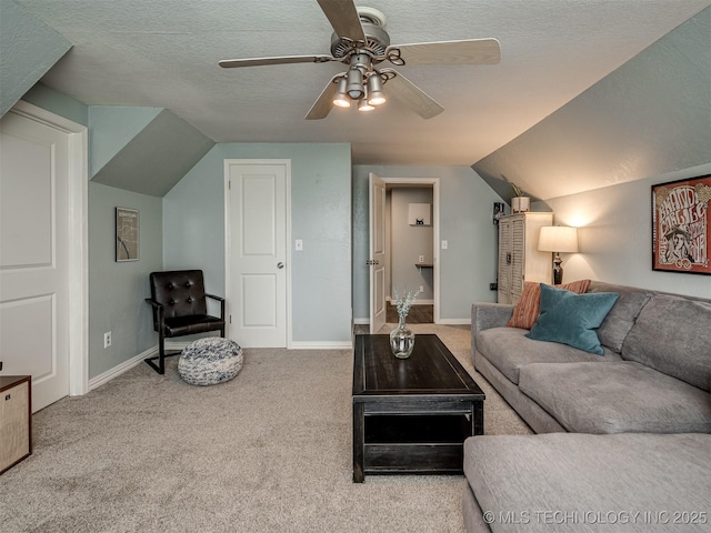 carpeted living area featuring baseboards, lofted ceiling, a textured ceiling, and a ceiling fan