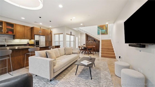 living area with recessed lighting, stairs, and visible vents