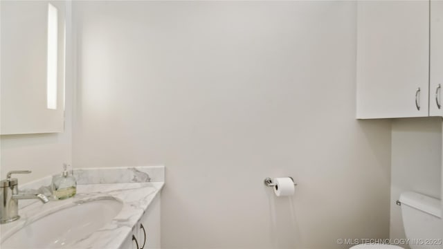 bathroom with toilet and vanity