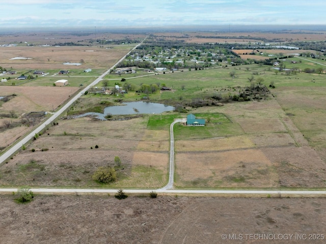 birds eye view of property featuring a water view and a rural view