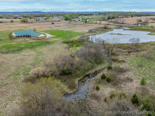birds eye view of property featuring a water view and a rural view