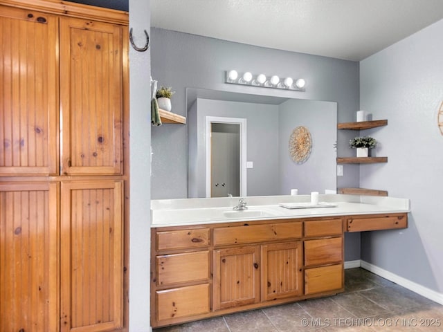 bathroom with baseboards and vanity