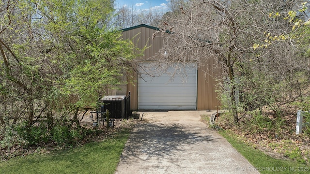 5980 Rolling Oaks, Muskogee, OK 74401 - garage featuring driveway and central AC unit