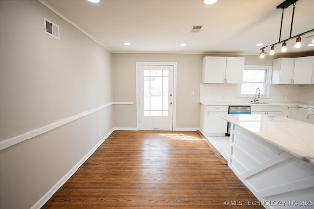 5760 E 29th St, Tulsa, OK 74114 - kitchen with wood finished floors, a sink, baseboards, and visible vents
