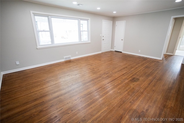 5760 E 29th St, Tulsa, OK 74114 - spare room with dark wood-style flooring, visible vents, crown molding, baseboards, and recessed lighting