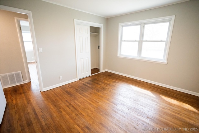 5760 E 29th St, Tulsa, OK 74114 - unfurnished bedroom featuring a closet, wood finished floors, baseboards, visible vents, and ornamental molding