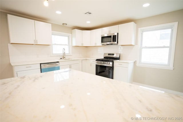 5760 E 29th St, Tulsa, OK 74114 - kitchen featuring visible vents, a sink, stainless steel appliances, and tasteful backsplash