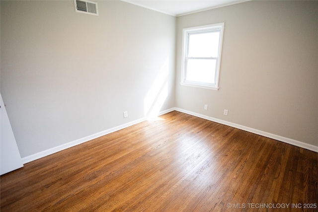 5760 E 29th St, Tulsa, OK 74114 - empty room featuring baseboards, visible vents, and wood finished floors