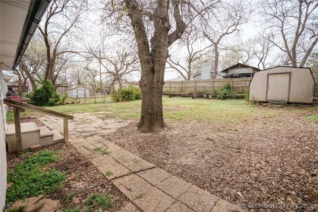 5760 E 29th St, Tulsa, OK 74114 - view of yard featuring a storage unit, an outbuilding, and fence