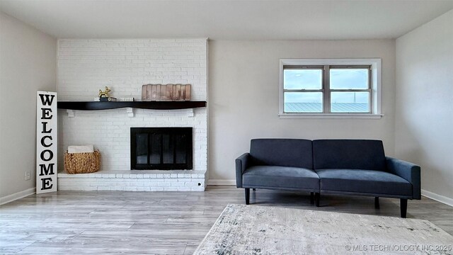 1721 S 114th E Ave, Tulsa, OK 74128 - living room with a brick fireplace, baseboards, and wood finished floors