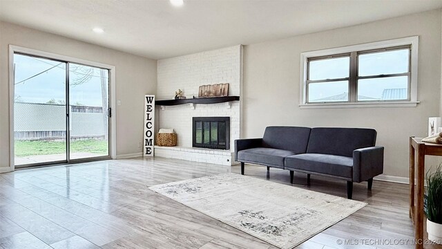 1721 S 114th E Ave, Tulsa, OK 74128 - living area with baseboards, wood finished floors, recessed lighting, and a brick fireplace
