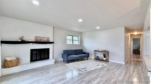 1721 S 114th E Ave, Tulsa, OK 74128 - sitting room featuring baseboards, a fireplace, and wood finished floors