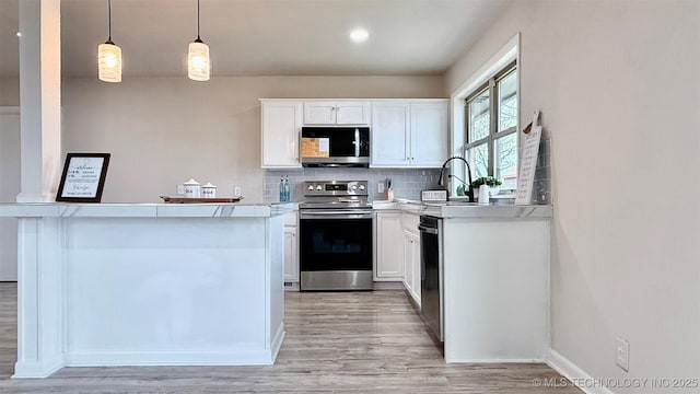 1721 S 114th E Ave, Tulsa, OK 74128 - kitchen featuring light countertops, backsplash, light wood finished floors, appliances with stainless steel finishes, and white cabinets