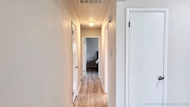 1721 S 114th E Ave, Tulsa, OK 74128 - hall with baseboards, visible vents, and light wood finished floors