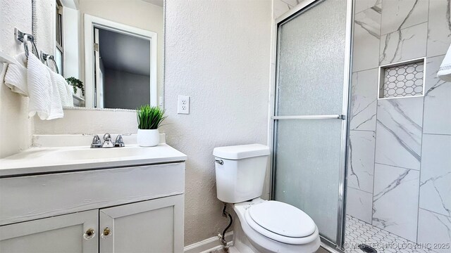 1721 S 114th E Ave, Tulsa, OK 74128 - bathroom featuring toilet, vanity, a shower stall, baseboards, and a textured wall
