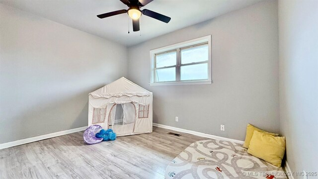 1721 S 114th E Ave, Tulsa, OK 74128 - playroom with baseboards, visible vents, a ceiling fan, and wood finished floors
