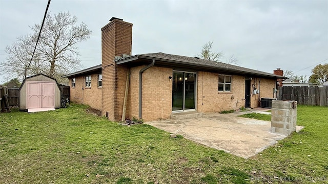1721 S 114th E Ave, Tulsa, OK 74128 - back of house featuring a chimney, a shed, fence, and a patio area