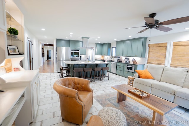 living area with recessed lighting and a ceiling fan
