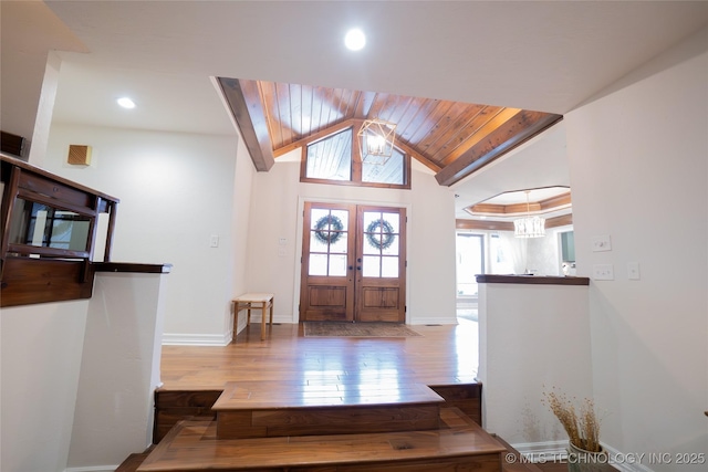 foyer entrance featuring hardwood / wood-style flooring, lofted ceiling, baseboards, recessed lighting, and wood ceiling
