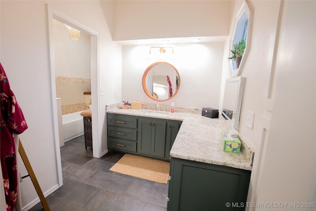 bathroom with vanity, a bathtub, and tile patterned flooring